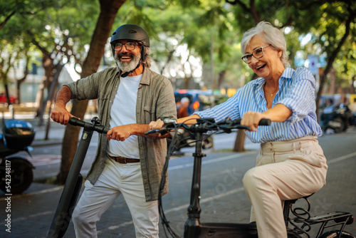 Stylish senior couple with electric transportation.