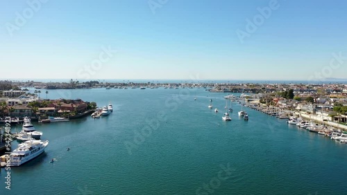Wallpaper Mural Forward Aerial Shot of Pacific Ocean Flying Over Inlet with Boats Cruising  Through Balboa Penninsula in Newport Beach, California Torontodigital.ca