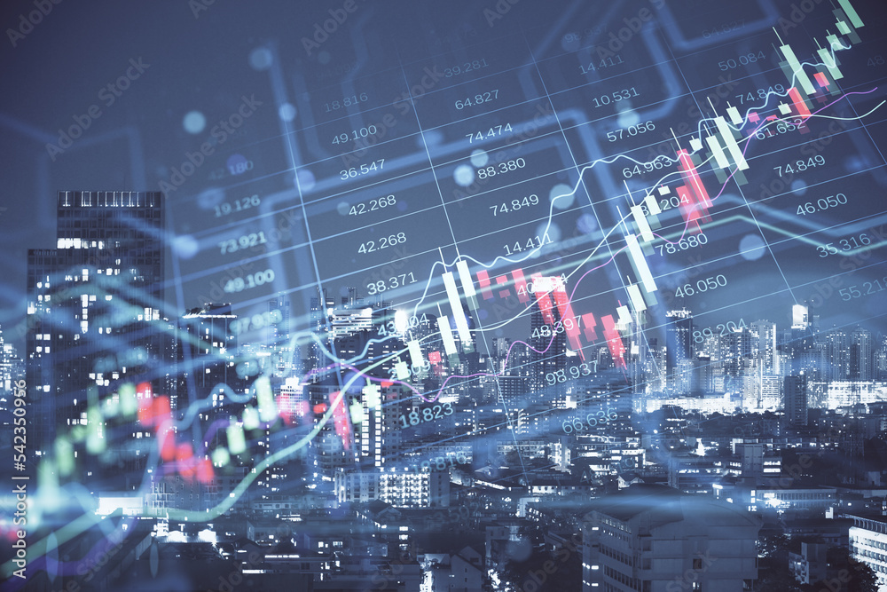 Creative candlestick forex chart index hologram on blurry night city buildings backdrop. Trade, business market and finance analysis concept. Double exposure.