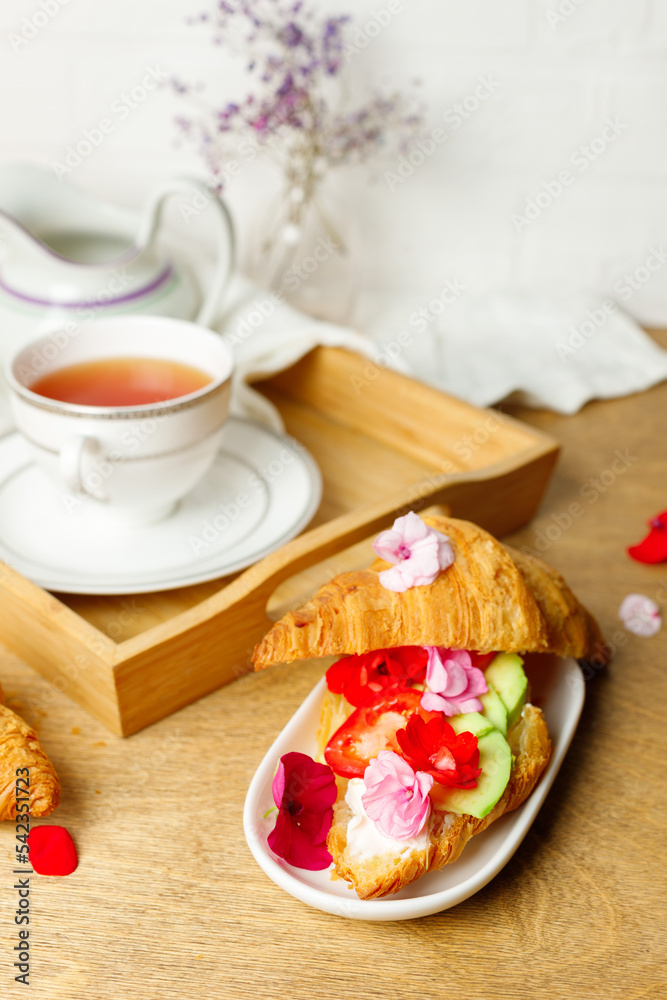 breakfast with croissants, a cup of tea and a creamer. Close-up. breakfast with croissants, a cup of tea and a creamer. Close-up.