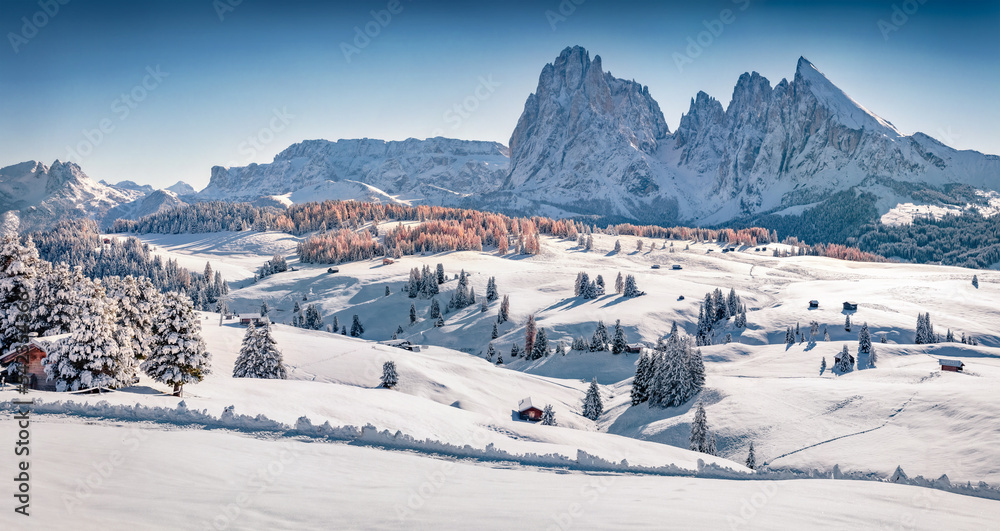 Christmas postcard. Beautiful winter view of Alpe di Siusi ski resort with Plattkofel peak on background. Spectacular morning scene of Dolomite Alps, Ityaly, Europe. Untouched winter landscape..