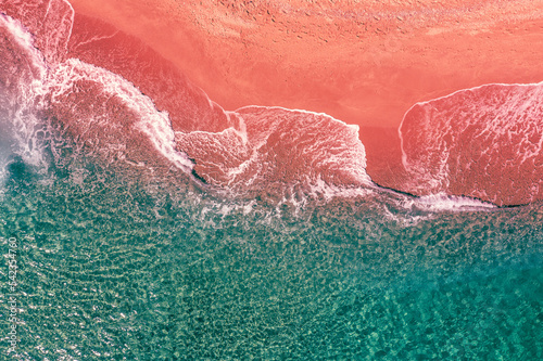 Sandy sea coast. Sea surf on the sandy beach. View from above. Artistic red-green color. gradient color