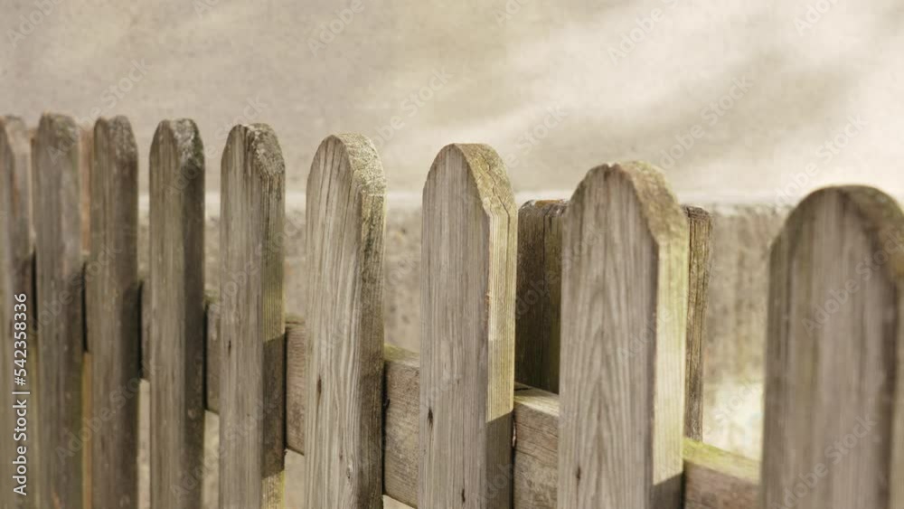 Wooden plank fence with shadow on cement wall Wooden plank fence with shadow on cement wall