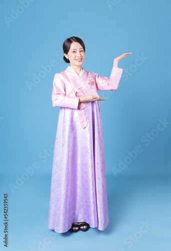 Image of young Korean woman wearing hanbok on background