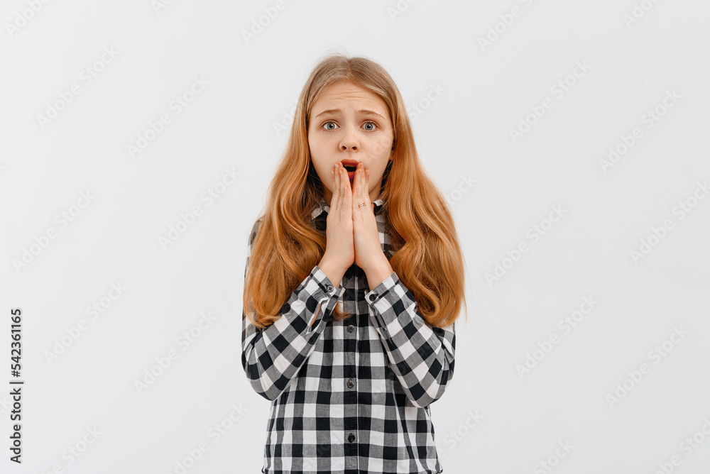 I can not believe it. Portrait of surprised, shocked teen girl looking at camera with amazed face, grab face scream impressed breaking news, standing in casual shirt over white background I can not believe it. Portrait of surprised, shocked teen girl looking at camera with amazed face, grab face scream impressed breaking news, standing in casual shirt over white background