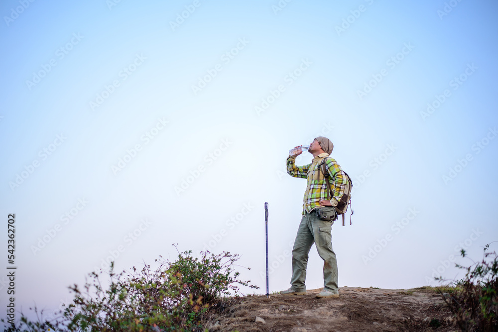 Portrait of Hiker man with backpack drinking water Portrait of Hiker man with backpack drinking water