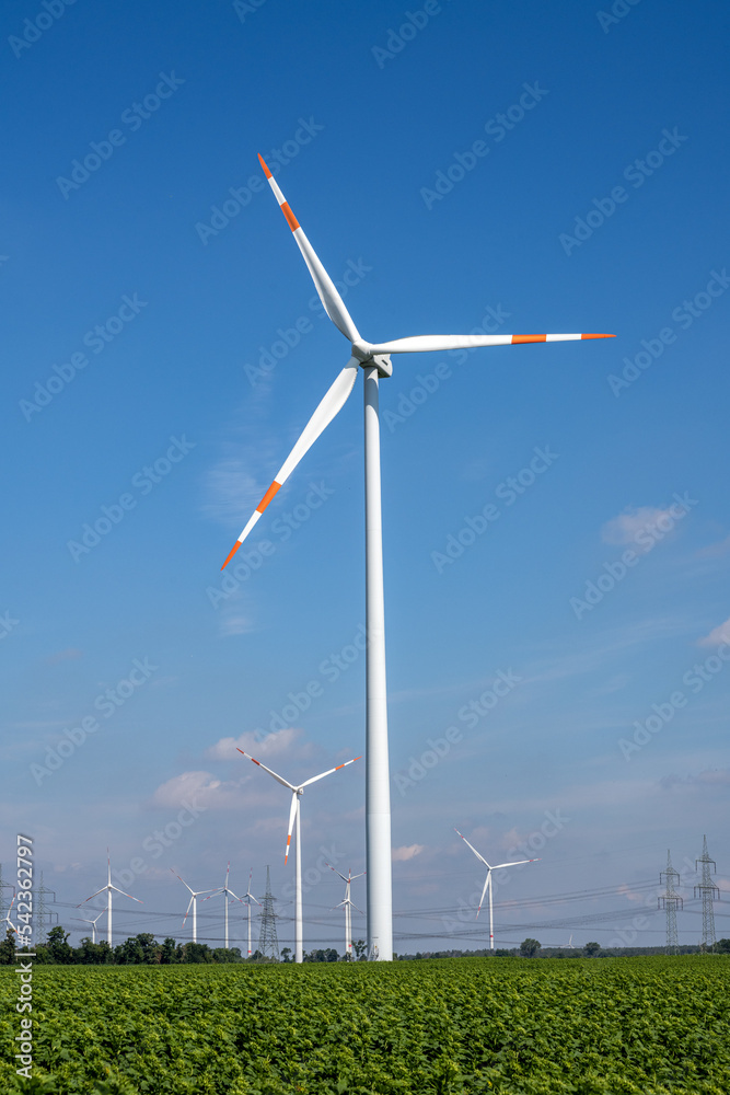Wind turbines with power lines on a beautiful sunny day in Germany Wind turbines with power lines on a beautiful sunny day in Germany