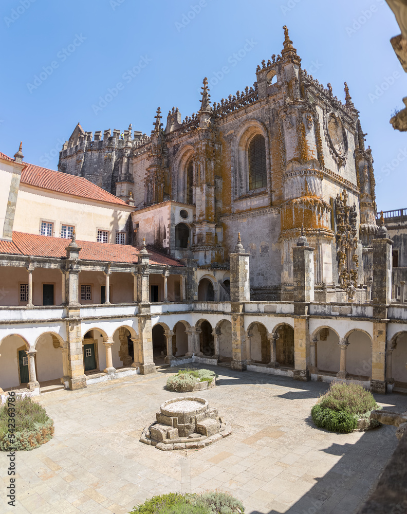 View at the Hospedaria cloister, Lodging cloister, Charola gothic main building as background, tourist people visiting, UNESCO heritage building Convent of Christ, Tomar