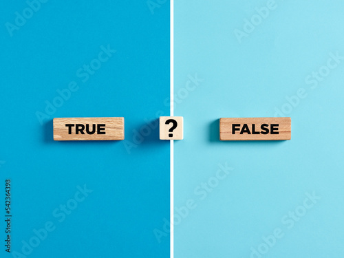 The words true and false on wooden blocks with question mark symbol.