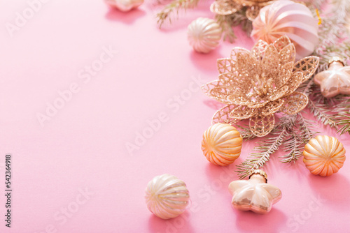 golden christmas decorations on pink background