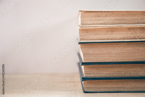 Old books stacked on a white background.