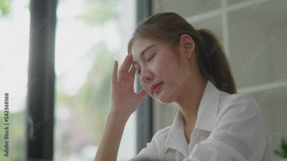 Young business woman stressed and headaches and office syndrome while working on laptop in office space. Young business woman stressed and headaches and office syndrome while working on laptop in office space.