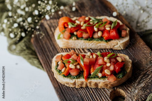Bruschetta with pesto, tomatoes and nuts