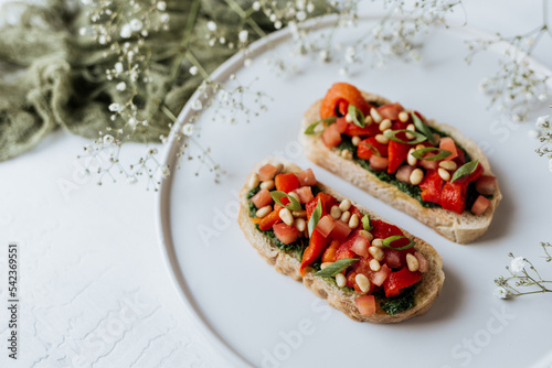 Bruschetta with pesto, tomatoes and nuts