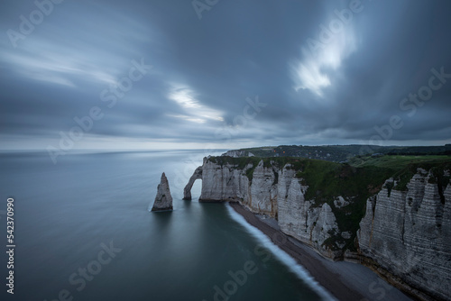 France, Normandy, Etretat,FalaisedAvalcliffs andAiguilledEtretatsea stack at cloudy dusk photo