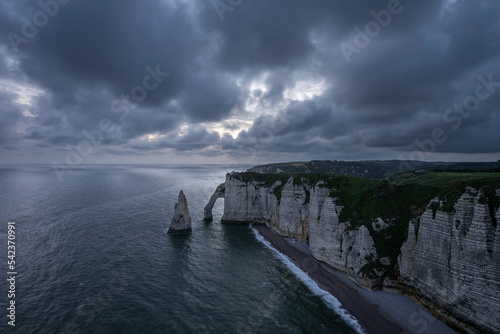 France, Normandy, Etretat,FalaisedAvalcliffs andAiguilledEtretatsea stack at cloudy dusk photo