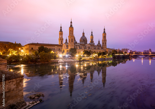 Scenic landscape with the Basilica of El Pilar in Zaragoza at sunrise reflected in the Ebro river