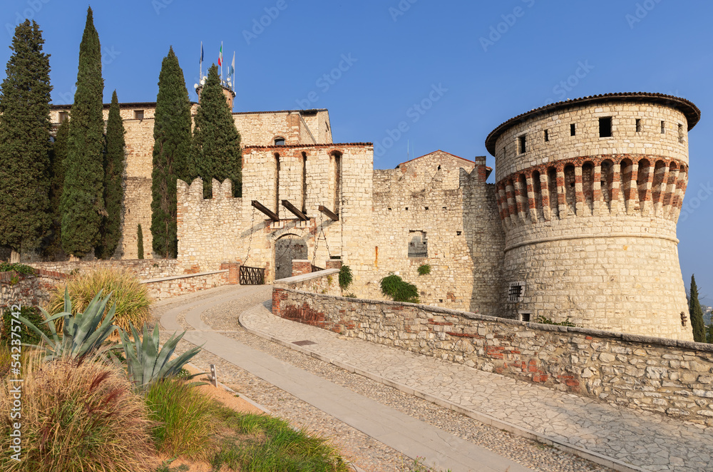 Entrance to the castle of Brescia town with drawbridge and Tower of Prisoners (Torre dei Prigionieri) Lombardy, Italy