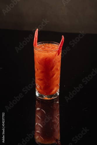 Tomato cocktail blood mary on the black background photo