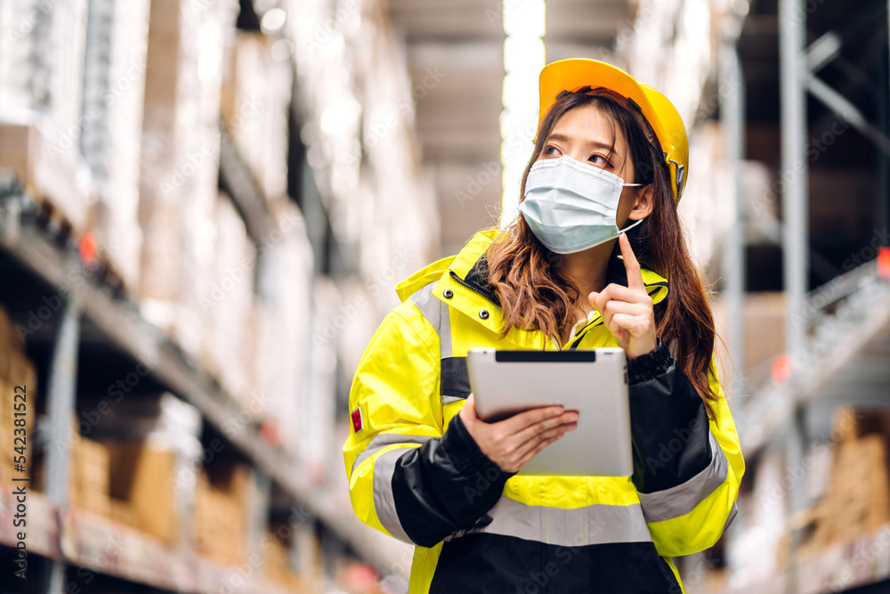 Portrait asian engineer woman shipping order detail on tablet check goods and supplies on shelves with goods background inventory in factory warehouse.logistic industry and business export