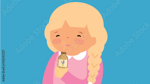 Girl sniffing a bottle of essential oil