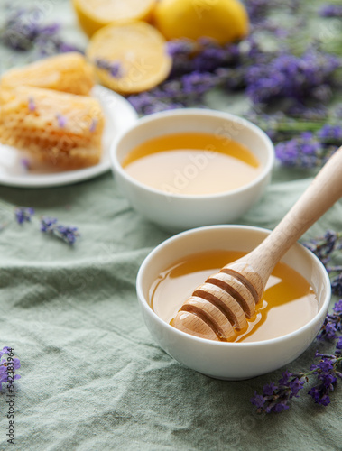 Jar with honey and fresh lavender flowers