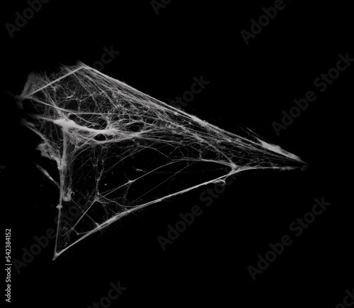 Foto White spiderweb on on black grunge background, cobweb scary frames