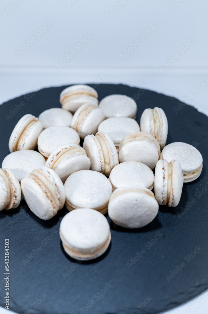 White vanilla macarons, black dish, french dessert