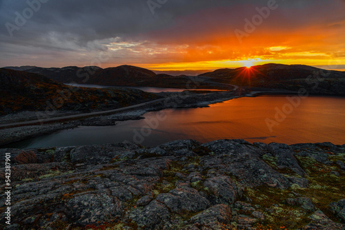 Beautiful sunset against the backdrop of mountains and a lake in Teriberka