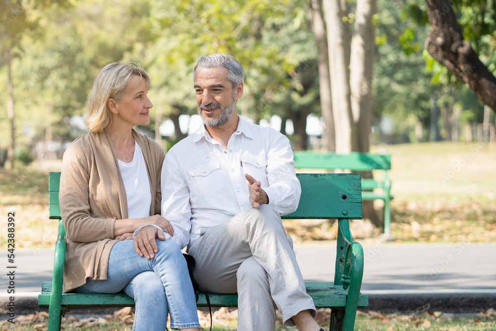 Elderly couple lifestyle concept. Husband embrace wife and sit on seat in the park relax on retirement life. Elderly couple lifestyle concept. Husband embrace wife and sit on seat in the park relax on retirement life.