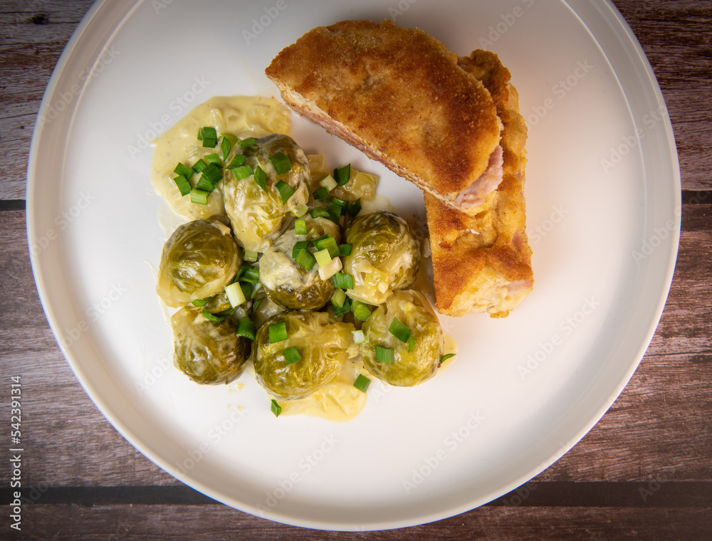 Recipe for homemade chicken fillet cordon bleu style with Brussels sprouts. High quality photo Recipe for homemade chicken fillet cordon bleu style with Brussels sprouts. High quality photo