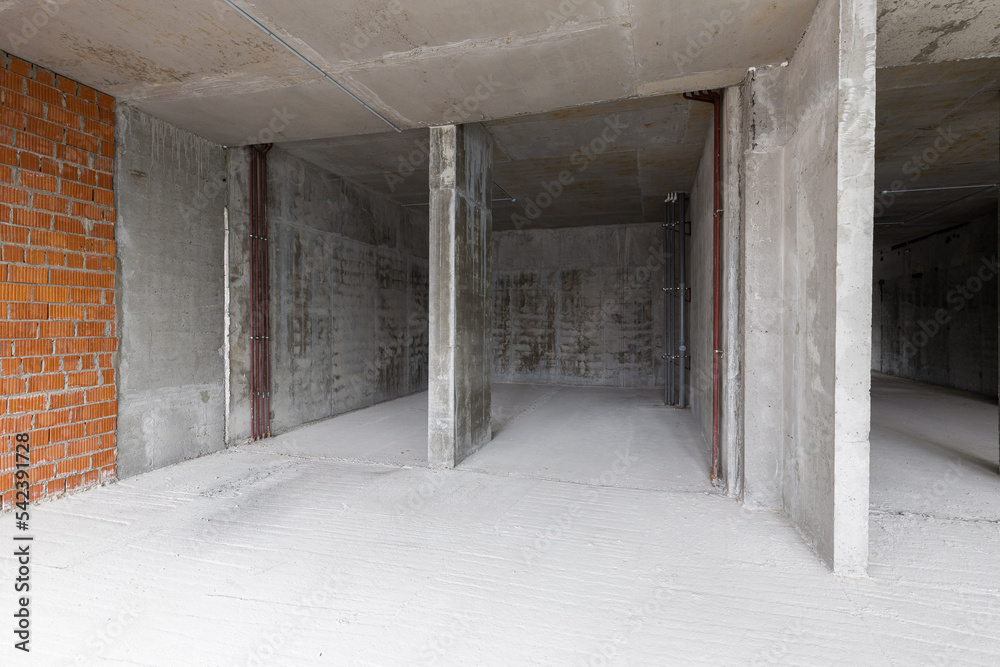 Empty concrete commercial space without finishing with partitions Empty concrete commercial space without finishing with partitions