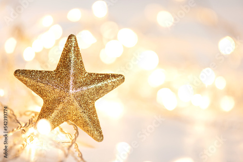 Christmas lights and golden star with abstract defocused bokeh lights. copy space