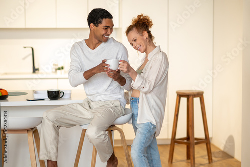 Cute couple in the kitchen looking happy