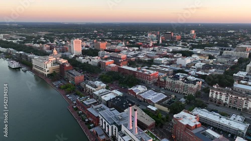 Aerial establishing shot of Savannah Georgia and riverfront riverwalk district. Sunset in Chatham County downtown. photo
