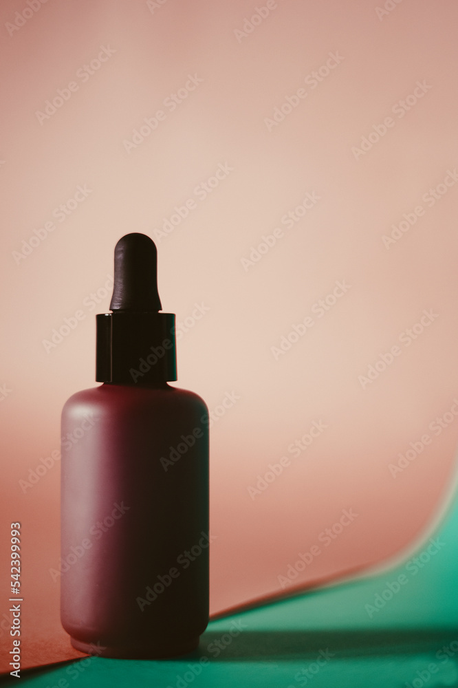 Skin care lotion or serum on red background.