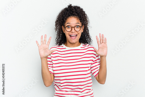 Young african american woman isolated receiving a pleasant surprise, excited and raising hands.