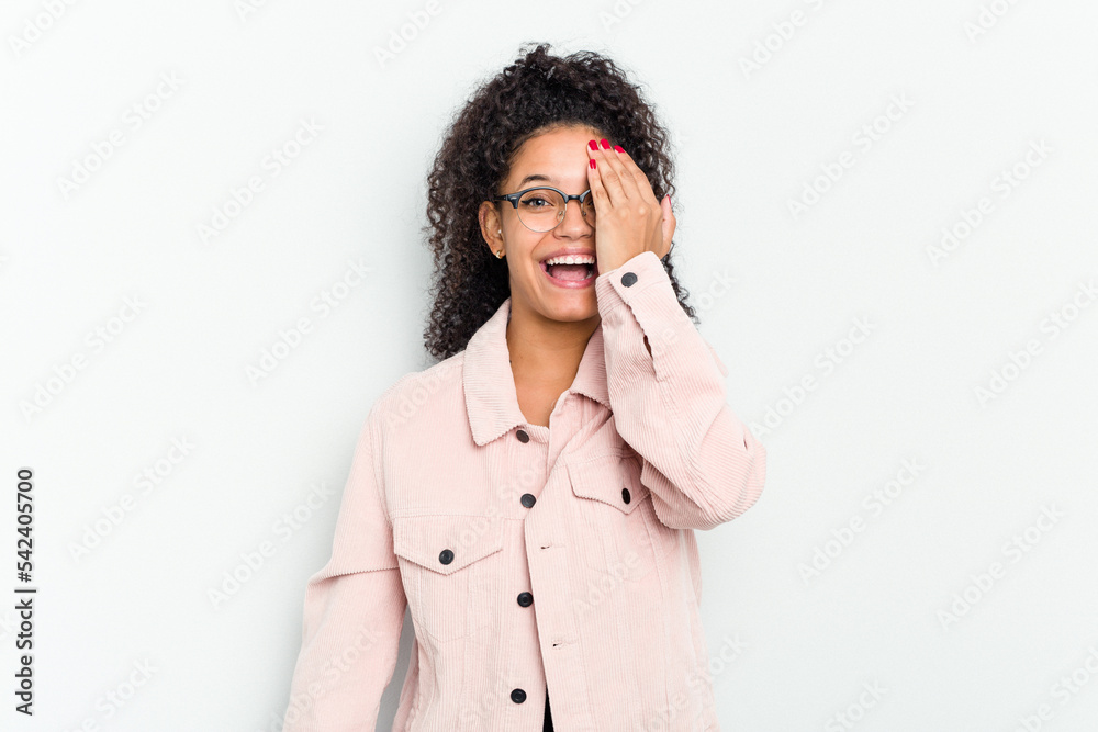 Young african american woman isolated having fun covering half of face with palm. Young african american woman isolated having fun covering half of face with palm.