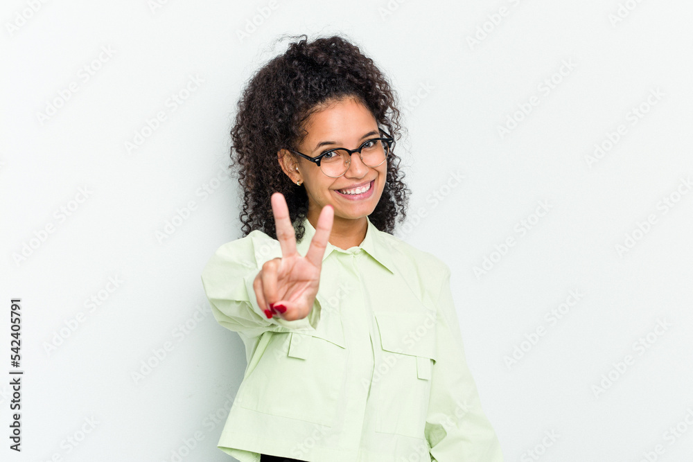 Young african american woman isolated joyful and carefree showing a peace symbol with fingers. Young african american woman isolated joyful and carefree showing a peace symbol with fingers.