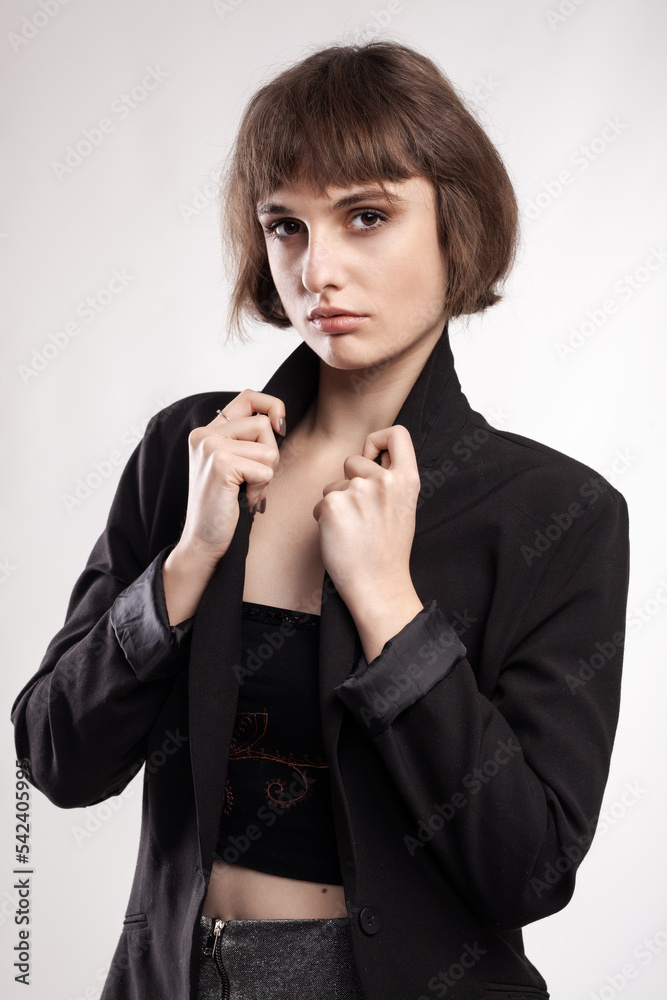 studio portrait of a beautiful girl with short hair wearing business casual outfit. studio portrait of a beautiful girl with short hair wearing business casual outfit.