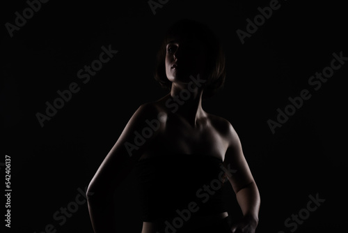 dark side lit beauty portrait of a lady with short hair