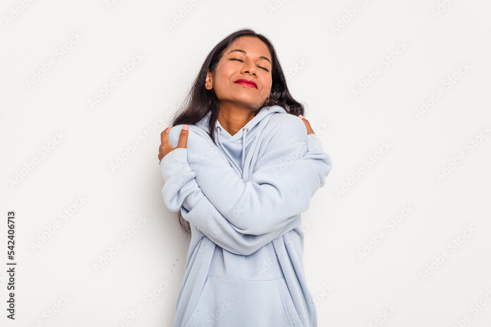 Young Indian woman isolated on white background hugs, smiling carefree and happy. Young Indian woman isolated on white background hugs, smiling carefree and happy.