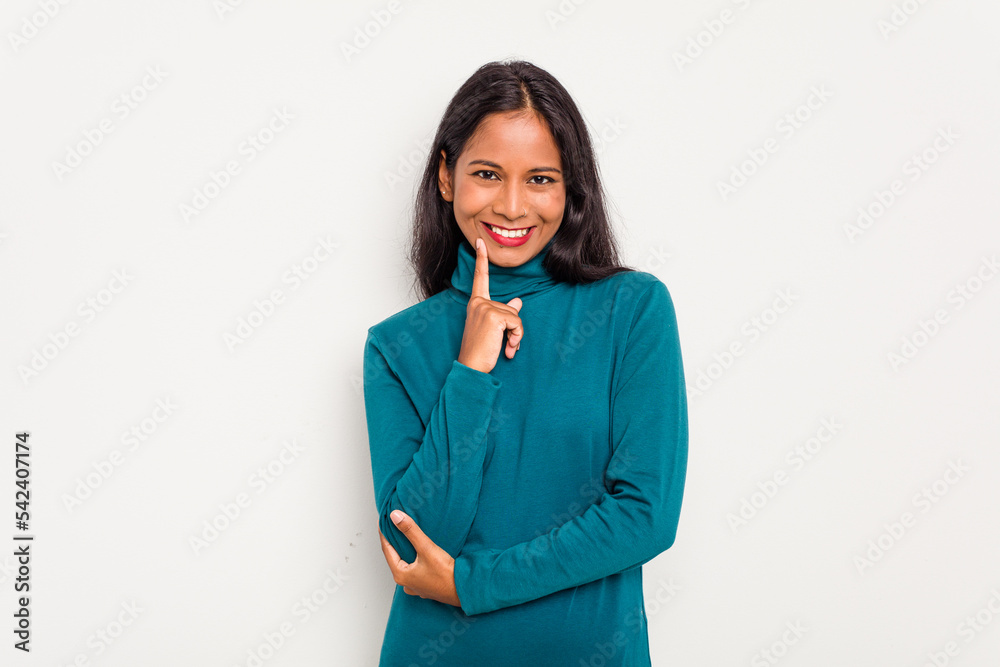 Young Indian woman isolated on white background smiling happy and confident, touching chin with hand. Young Indian woman isolated on white background smiling happy and confident, touching chin with hand.