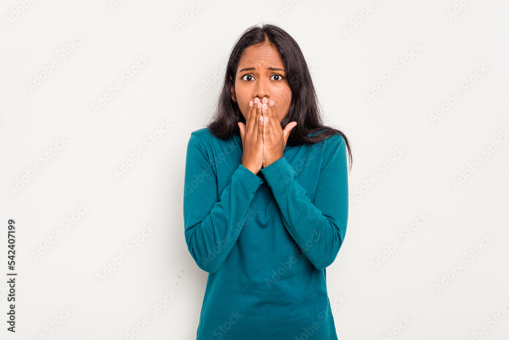 Young Indian woman isolated on white background covering mouth with hands looking worried. Young Indian woman isolated on white background covering mouth with hands looking worried.