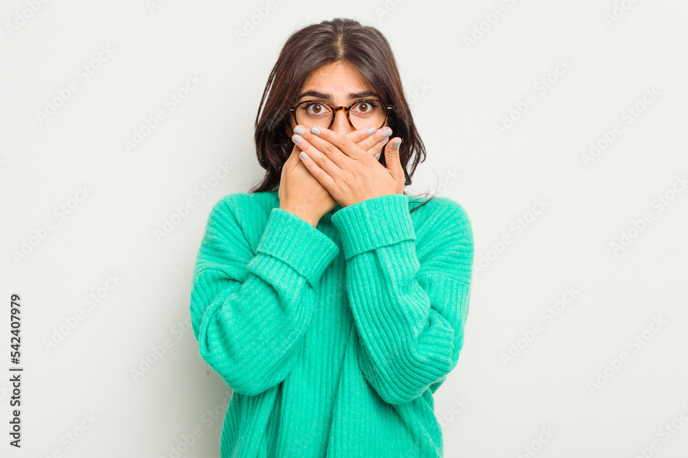 Young Indian woman isolated on white background covering mouth with hands looking worried. Young Indian woman isolated on white background covering mouth with hands looking worried.