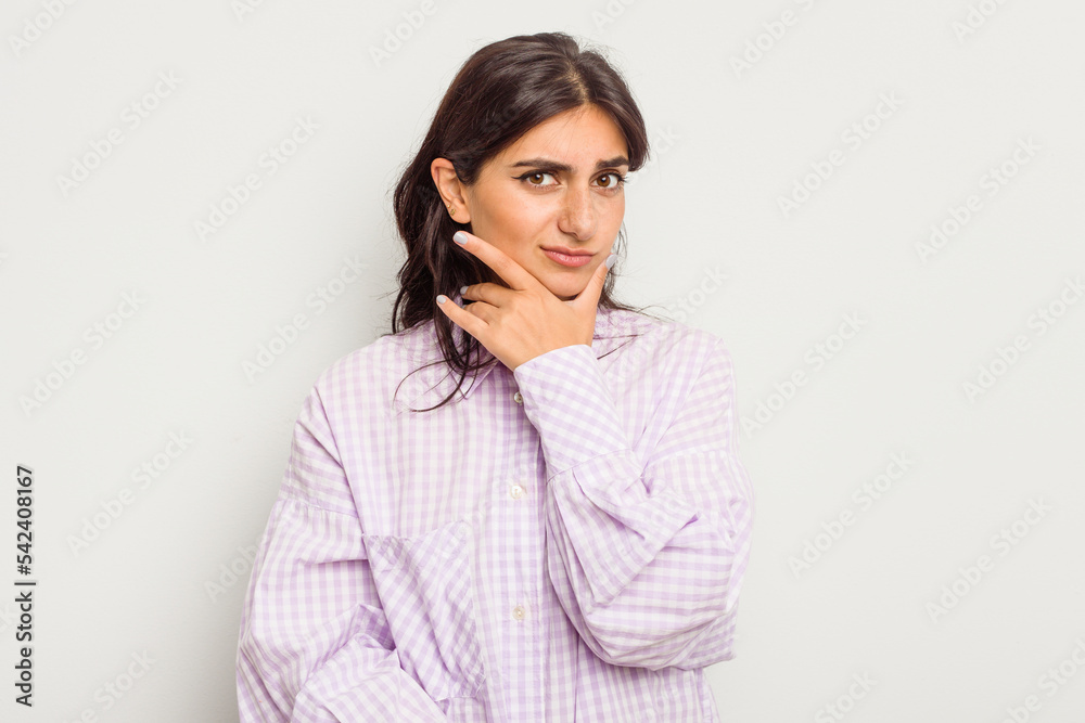 Young Indian woman isolated on white background contemplating, planning a strategy, thinking about the way of a business. Young Indian woman isolated on white background contemplating, planning a strategy, thinking about the way of a business.