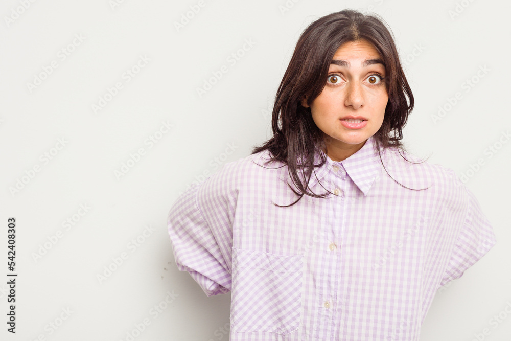 Young Indian woman isolated on white background being shocked because of something she has seen.