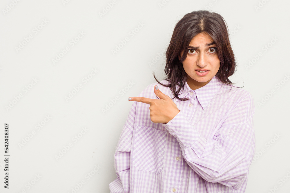 Young Indian woman isolated on white background pointing to the side Young Indian woman isolated on white background pointing to the side