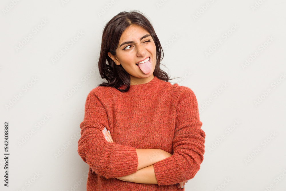 Young Indian woman isolated on white background funny and friendly sticking out tongue. Young Indian woman isolated on white background funny and friendly sticking out tongue.