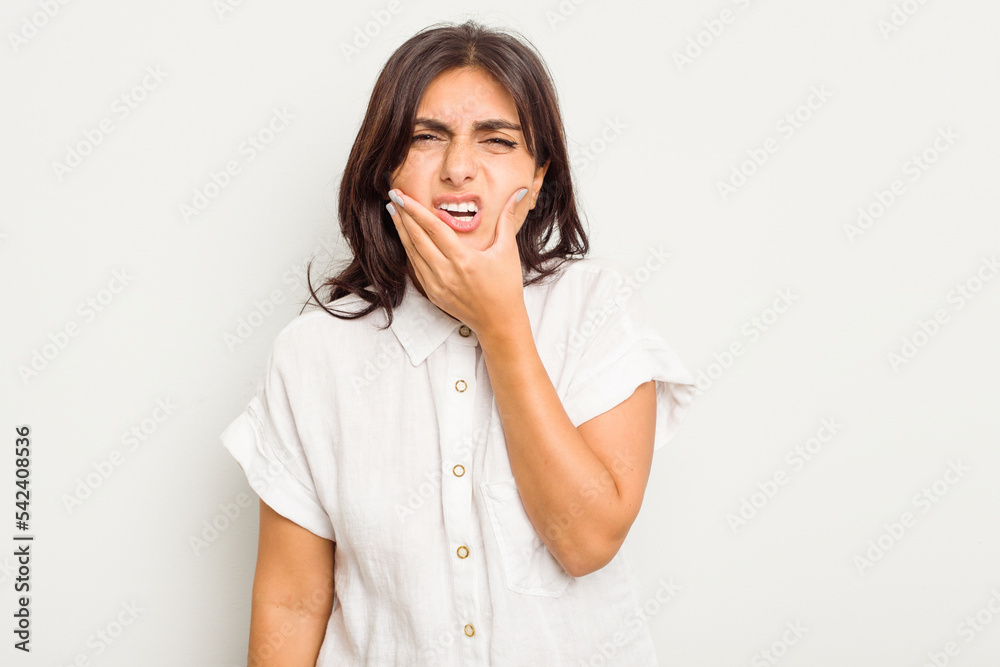 Young Indian woman isolated on white background having a strong teeth pain, molar ache. Young Indian woman isolated on white background having a strong teeth pain, molar ache.